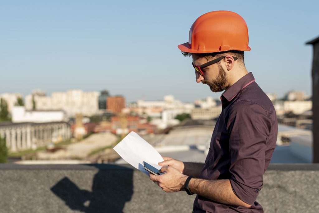 man-standing-rooftop-with-phone-hand